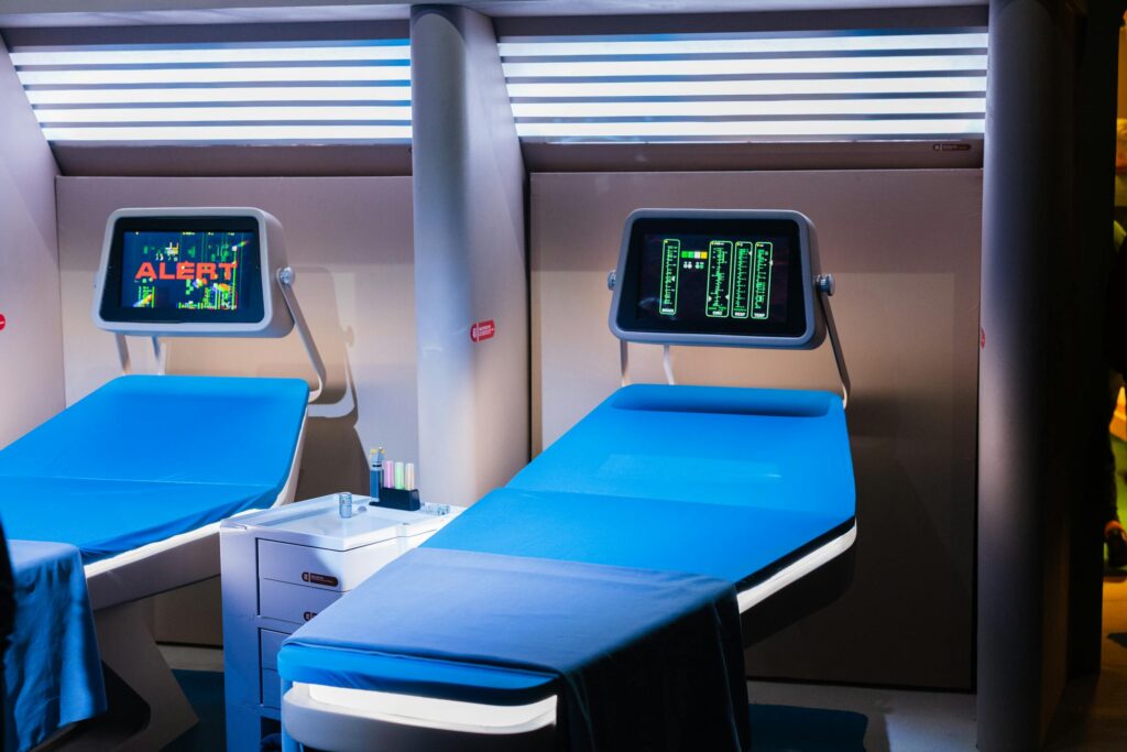 A modern hospital room featuring advanced medical equipment with digital displays.